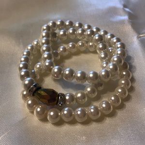 3 stretchy pearl bracelets with 1 purple tear drop